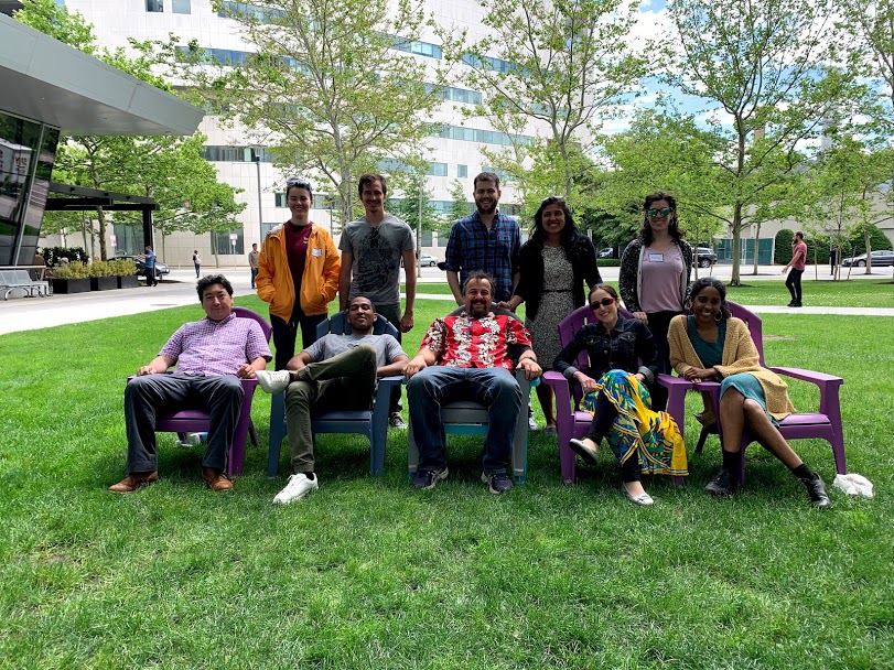 A group of undergraduate students in a group gathered in an outdoor setting.