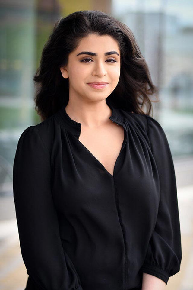 A young female research student smiling towards the camera