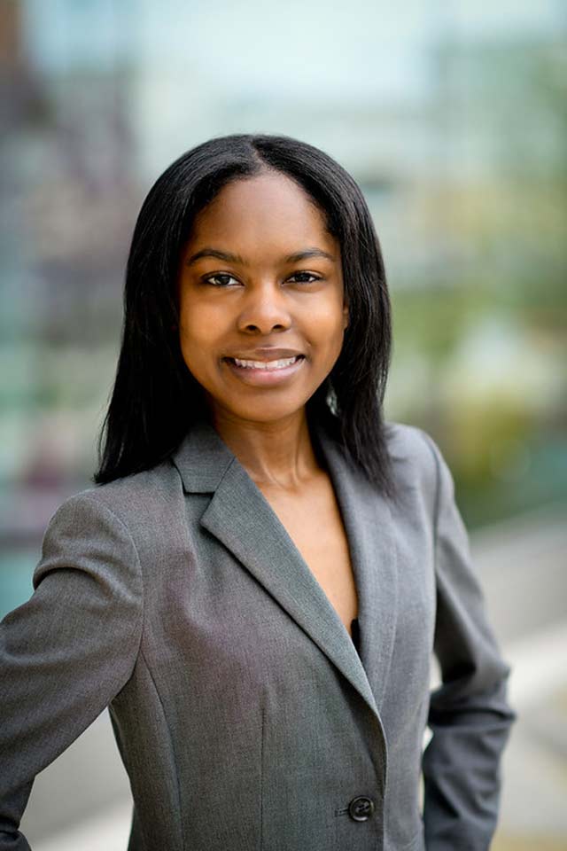 A young female research student confidently smiling towards the camera