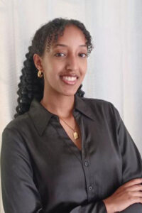 a three-quarter portrait of a young undergraduate student smiling.