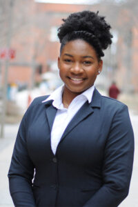 a three-quarter portrait of a young undergraduate student smiling.