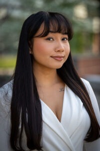 a three-quarter portrait of a young undergraduate student smiling.