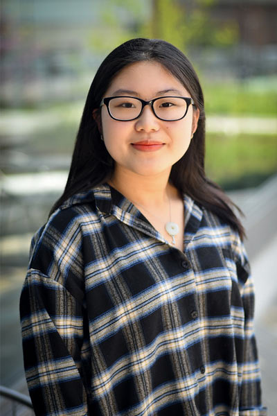 A three-quarter portrait of a young undergraduate smiling