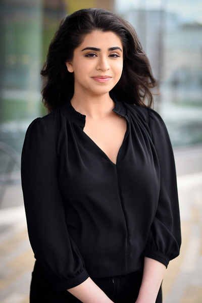A three-quarter portrait of a young undergraduate smiling