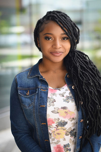 A three-quarter portrait of a young undergraduate smiling