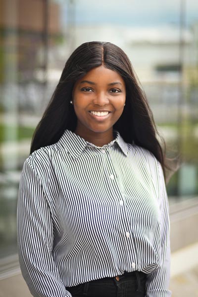 A three-quarter portrait of a young undergraduate smiling