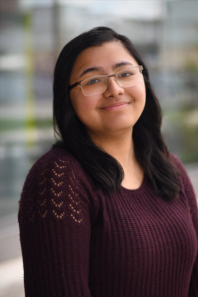 A three-quarter portrait of a young undergraduate smiling